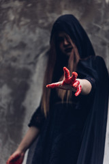 Portrait woman ghost devil and reach out hand have red blood