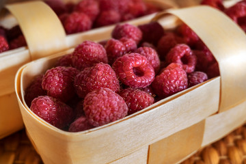 Fresh organic raspberry in basket. Selective focus.