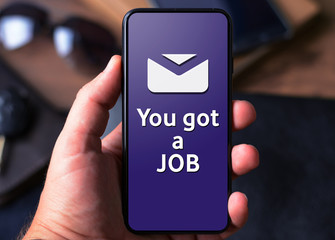 Hand with a smartphone with text You got a job