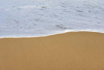 White Sea wave and sandy beach Background.Copy space