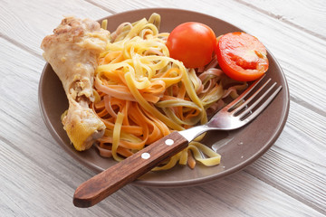 Traditional lunch with pasta and chicken meat on bone