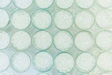 Pattern of glasses with ice ready to prepare a cocktail with refreshing background.