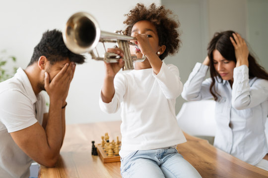 Picture of child making noise by playing trumpet