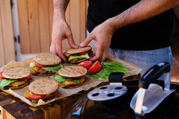 Male chef hands preparing hamburgers