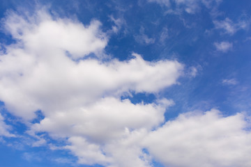 White clouds on blue sky background.