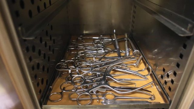 Metal surgical instruments in sterilization box. Analysis of coronavirus in animals. Animal treatment.  Waiting for the operation.  Medical instruments. Sterilization. Virus protection.