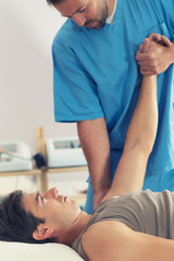 Obraz na płótnie Canvas Physiotherapist Working With Patient Arm