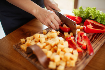 The beautiful lady cuts a red paper