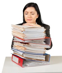 Businesswoman sitting at the table with many papers on
