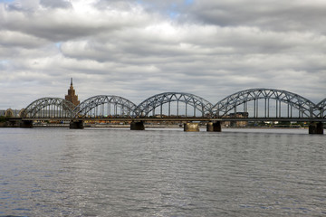 View on Railway Bridge over Daugava River and the building of the Academy of Sciences in Riga, Latvia....