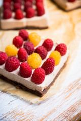 Fresh raspberry cheesecake on the rustic background. Selective focus. Shallow depth of field.
