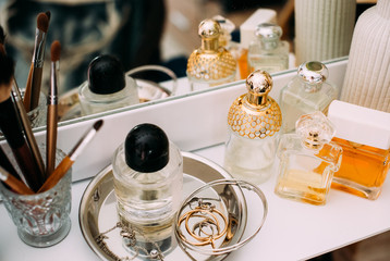 Perfumery and cosmetics on a dressing table with a mirror