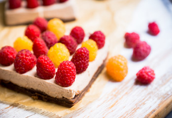 Fresh raspberry cheesecake on the rustic background. Selective focus. Shallow depth of field.