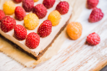 Fresh raspberry cheesecake on the rustic background. Selective focus. Shallow depth of field.