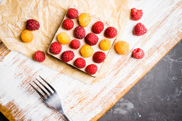 Fresh raspberry cheesecake on the rustic background. Selective focus. Shallow depth of field.