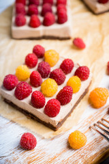 Fresh raspberry cheesecake on the rustic background. Selective focus. Shallow depth of field.