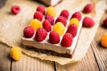 Fresh raspberry cheesecake on the rustic background. Selective focus. Shallow depth of field.