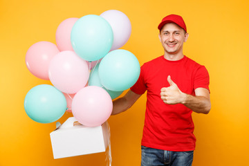 Man giving food order cake box isolated on yellow background. Male employee courier in red cap t-shirt hold colorful air balloons, dessert in empty cardboard box. Delivery service concept. Copy space.