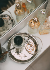 Perfumery and cosmetics on a dressing table with a mirror