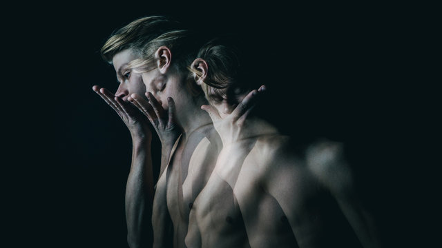 be silent. Don't speak. Young beautiful naked guy covers mouth with his hands. Multiple exposure. Creative emotional man portrait.
