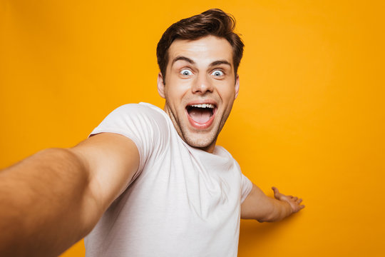 Portrait of an excited young man taking a selfie