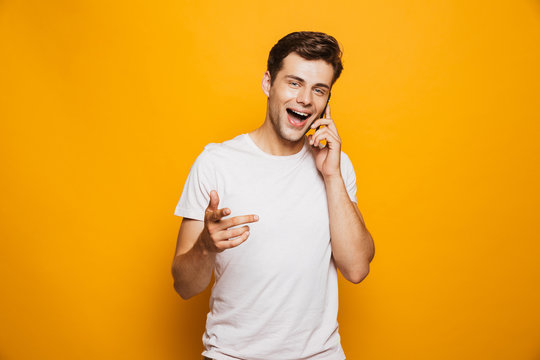 Portrait of a happy young man talking on mobile phone