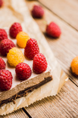 Fresh raspberry cheesecake on the rustic background. Selective focus. Shallow depth of field.
