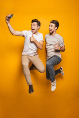 Full length portrait of a two excited young men