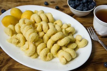 Snacks with flavoring, fresh apricots, black tea and blueberry   