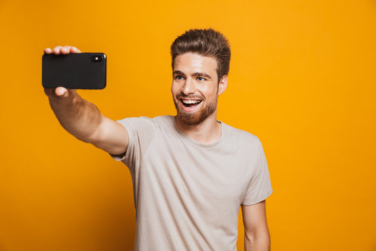 Portrait of a happy young man taking a selfie