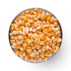 Dry corn in bowl on white background