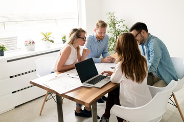 Team of young architects discussing about project