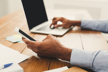 African-american businessman typing on laptop