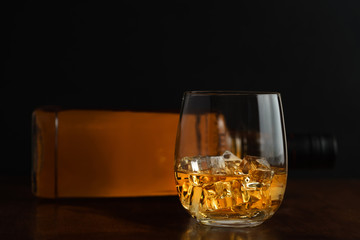 Glass of whiskey and it's bottle