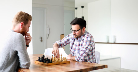 Two young man playing chess