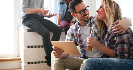 Cheerful couple using digital tablet