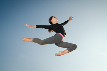 Fototapeta na wymiar Gymnast girl jumping
