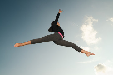 Fototapeta na wymiar Gymnast girl jumping