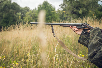 hunter with a gun on the steppe