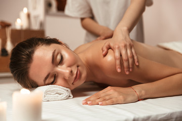 Smiling young woman having massage