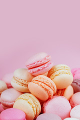 Fototapeta na wymiar Sweet macaroons with vintage pastel colored tone on pink background.