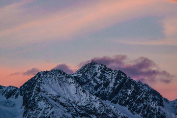Obraz premium Sunset over Snow covered Mountains