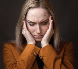 Cracks on the forehead - woman suffering from headache.