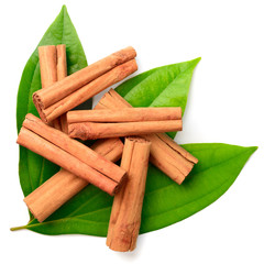 cinnamon sticks with fresh leaves isolatd on the white background, top view