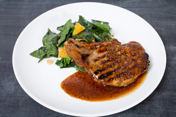 Grilled pork fillet with spinach salad.
