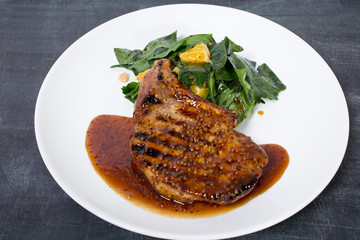 Grilled pork fillet with spinach salad.