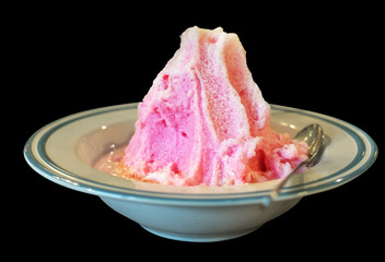 Bread with ice topped with pink milk fresh in bowl black background