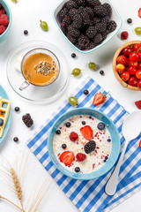 Photo of oatmeal, coffee, raspberries, strawberries, gooseberries, cherries