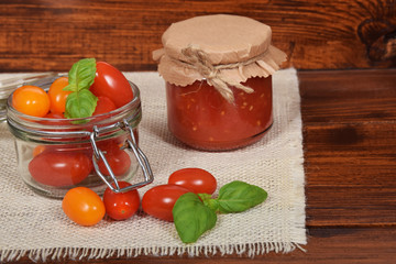 jar with tomato sauce for the winter, cherry tomatoes,