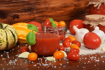 tomato juice with basil in a glass, cherry tomatoes, garlic, spices